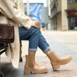Beige ankle boots with a chunky sole, perfect for a stylish and versatile look.