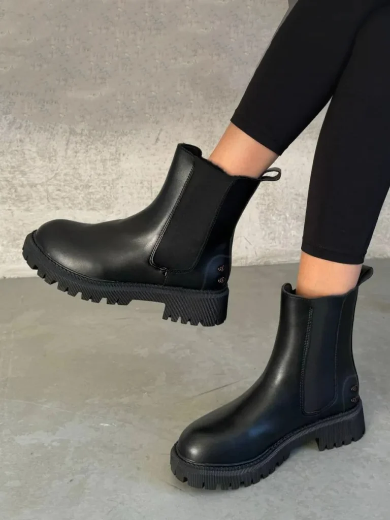 Chic black ankle boots with a durable chunky sole, designed for comfort and modern style.